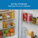 Avanti retro compact refrigerator with open door, showing shelves, bottles, and containers