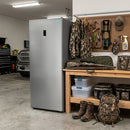 White upright freezer with front control panel beside a workbench