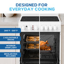 White electric range with four-burner ceramic glass cooktop and oven with food inside