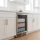 Beverage center refrigerator with glass door open, showing rows of canned drinks