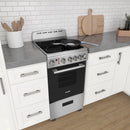 Stainless steel electric range with ceramic glass cooktop in a kitchen setup.
